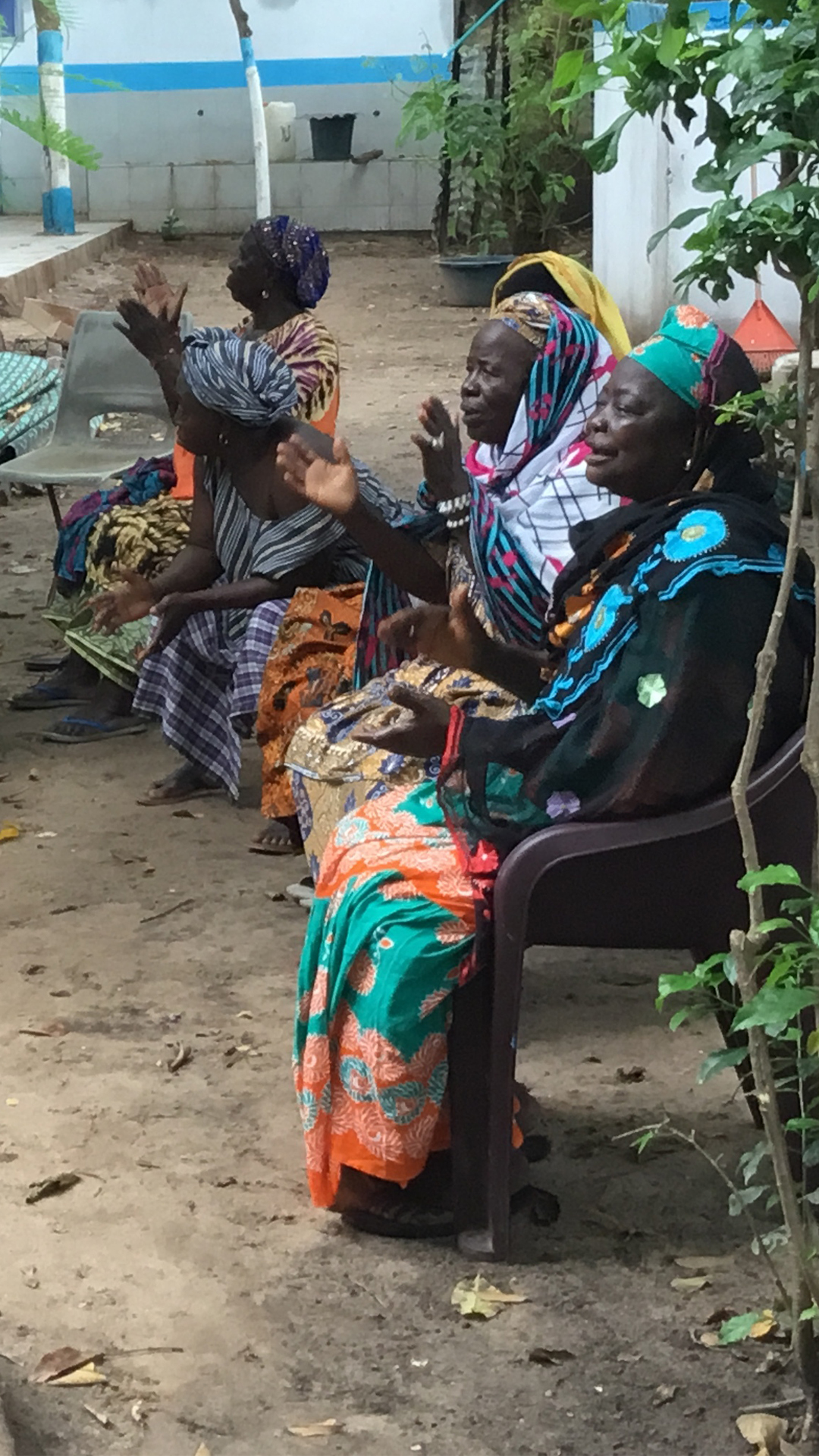 Members of the Bakau Kanyeleng share a moment together between songs and performances