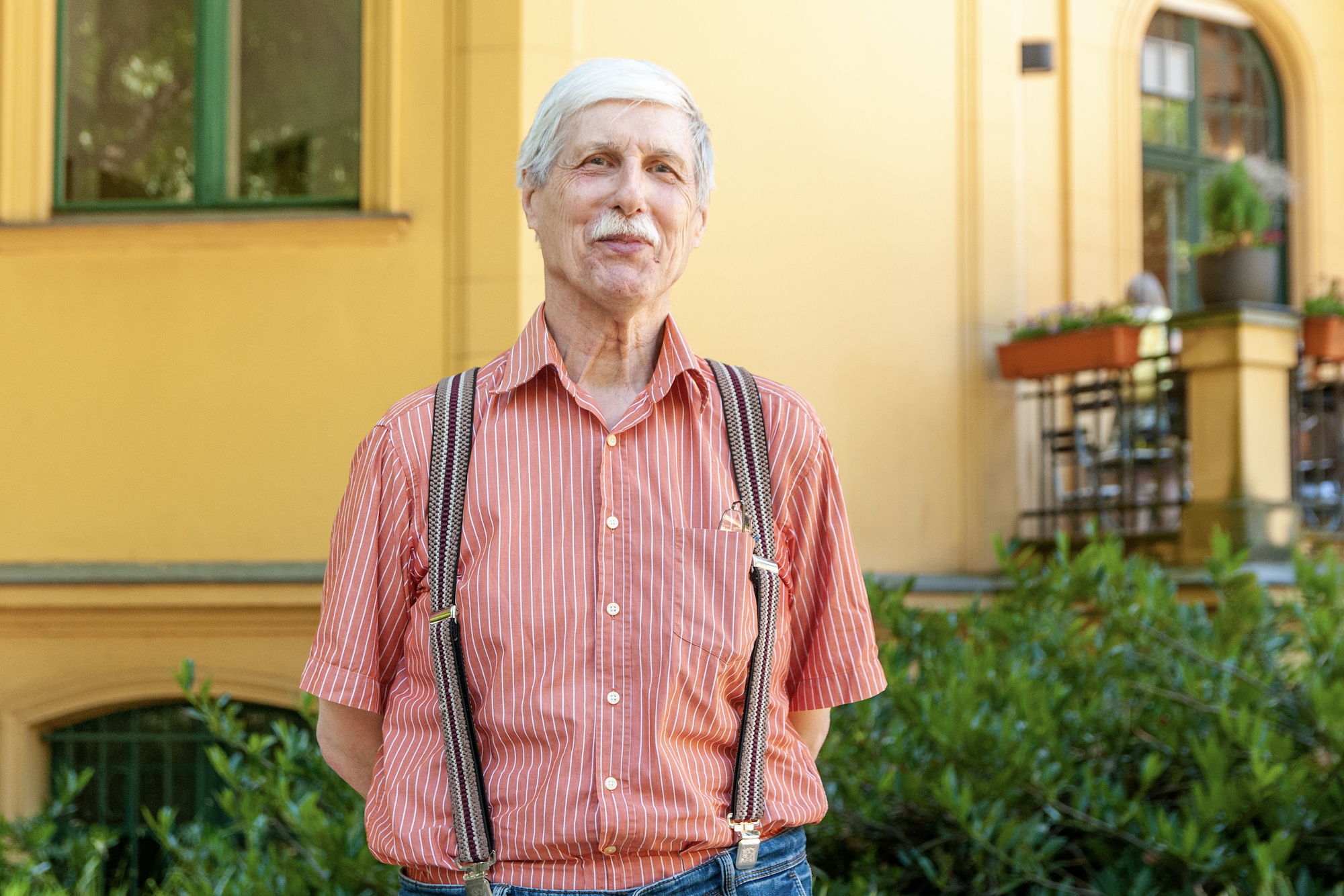 Ernst Guetinger poses outside his home in Berlin [Gouri Sharma/Al Jazeera]
