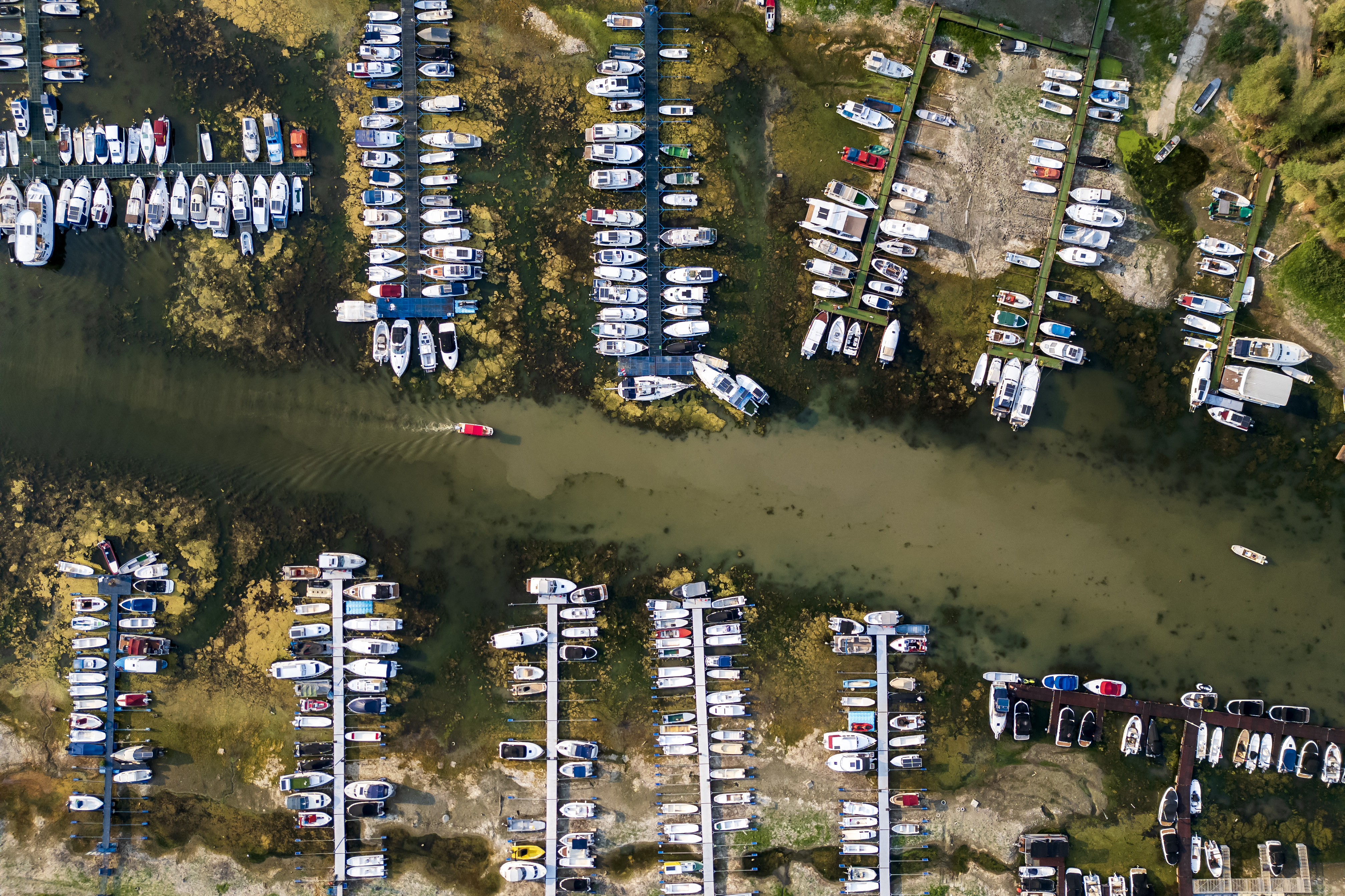 (FILES) This aerial photo shows boats in a marina left stranded on the river bed by the low water level of the Danube River in Novi Sad, Serbia, on August 7, 2026, as prolonged hot and dry weather continues to lower water levels across the country.