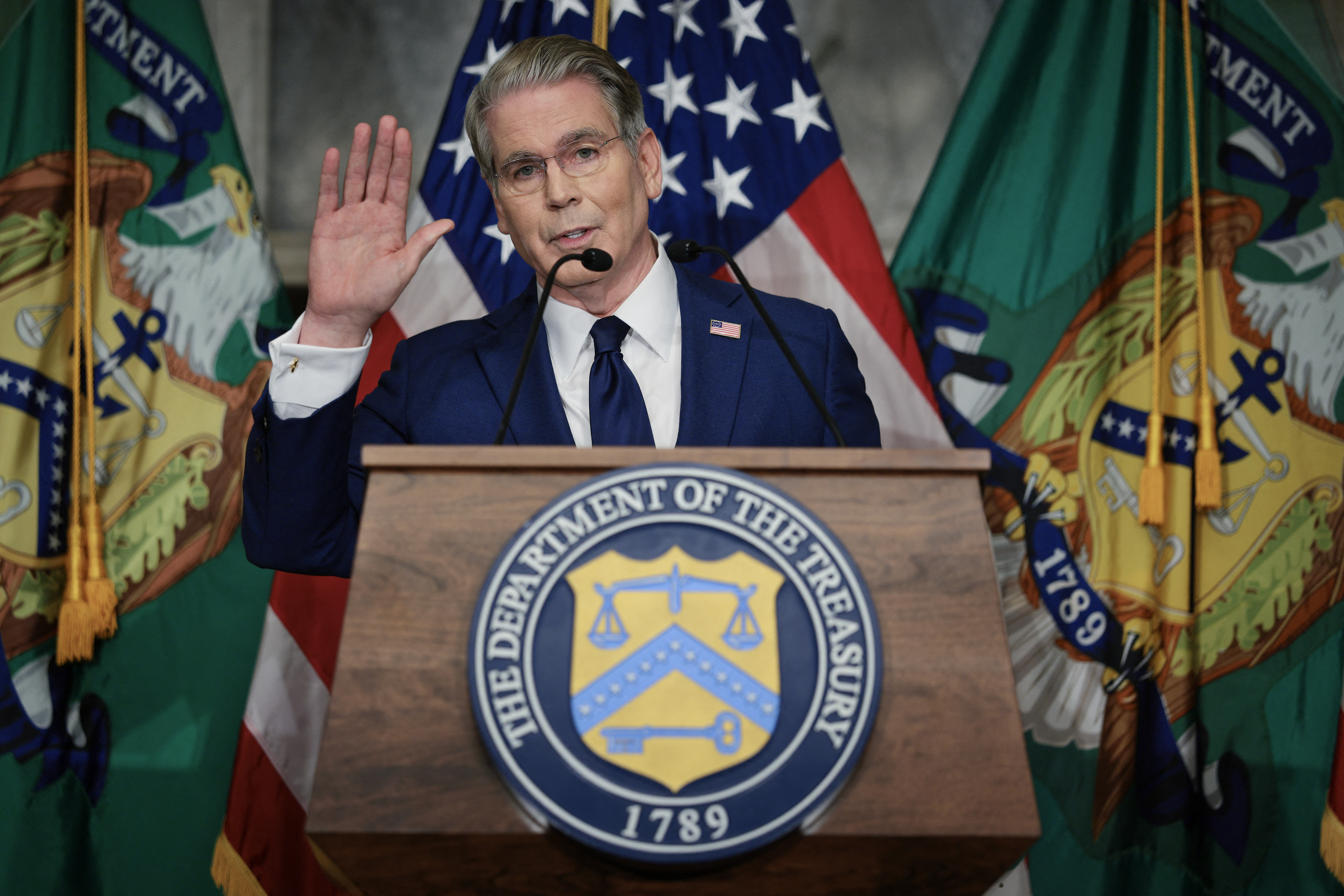 WASHINGTON, DC - AUGUST 24: U.S. Treasury Secretary Scott Bessent waves goodbye to reporters after announcing a new set of sanctions against Iran, describing them as "an economic D-Day", in the Cash Room at the Treasury Department on August 24, 2026 in Washington, DC. Bessent threatened Iran in an opinion piece in the Financial Times on Sunday with "the single greatest financial offensive ever", almost six months after the United States and Israel launched a war against Iran in February. Chip Somodevilla/Getty Images/AFP (Photo by CHIP SOMODEVILLA / GETTY IMAGES NORTH AMERICA / Getty Images via AFP)