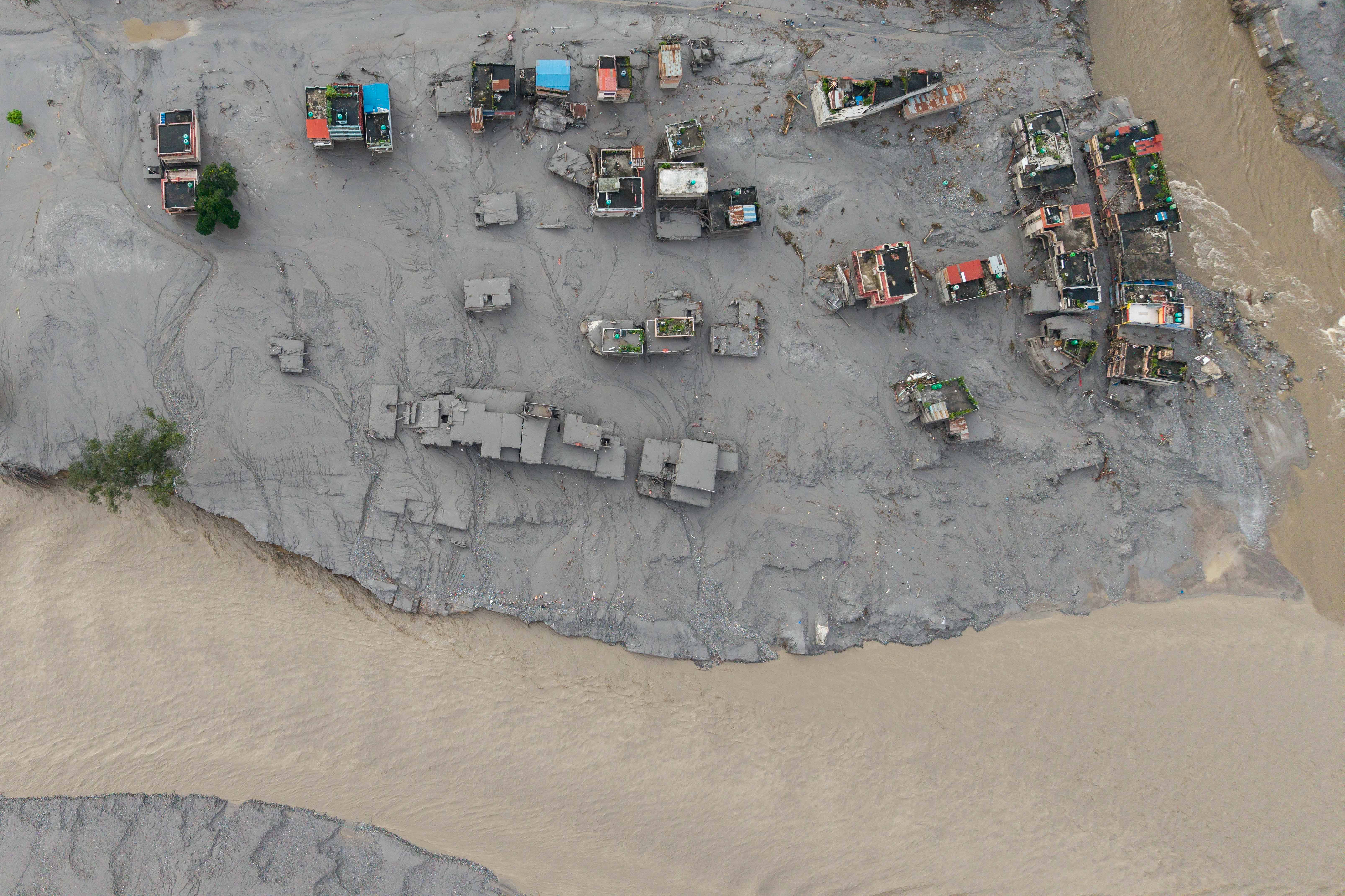 TOPSHOT - An aerial view shows houses lying deluged in sludge after flash floods at Devighat, Bidur Municipality, along the confluence of the Trishuli and Tadi rivers in Nepal's Nuwakot district on August 27, 2026.