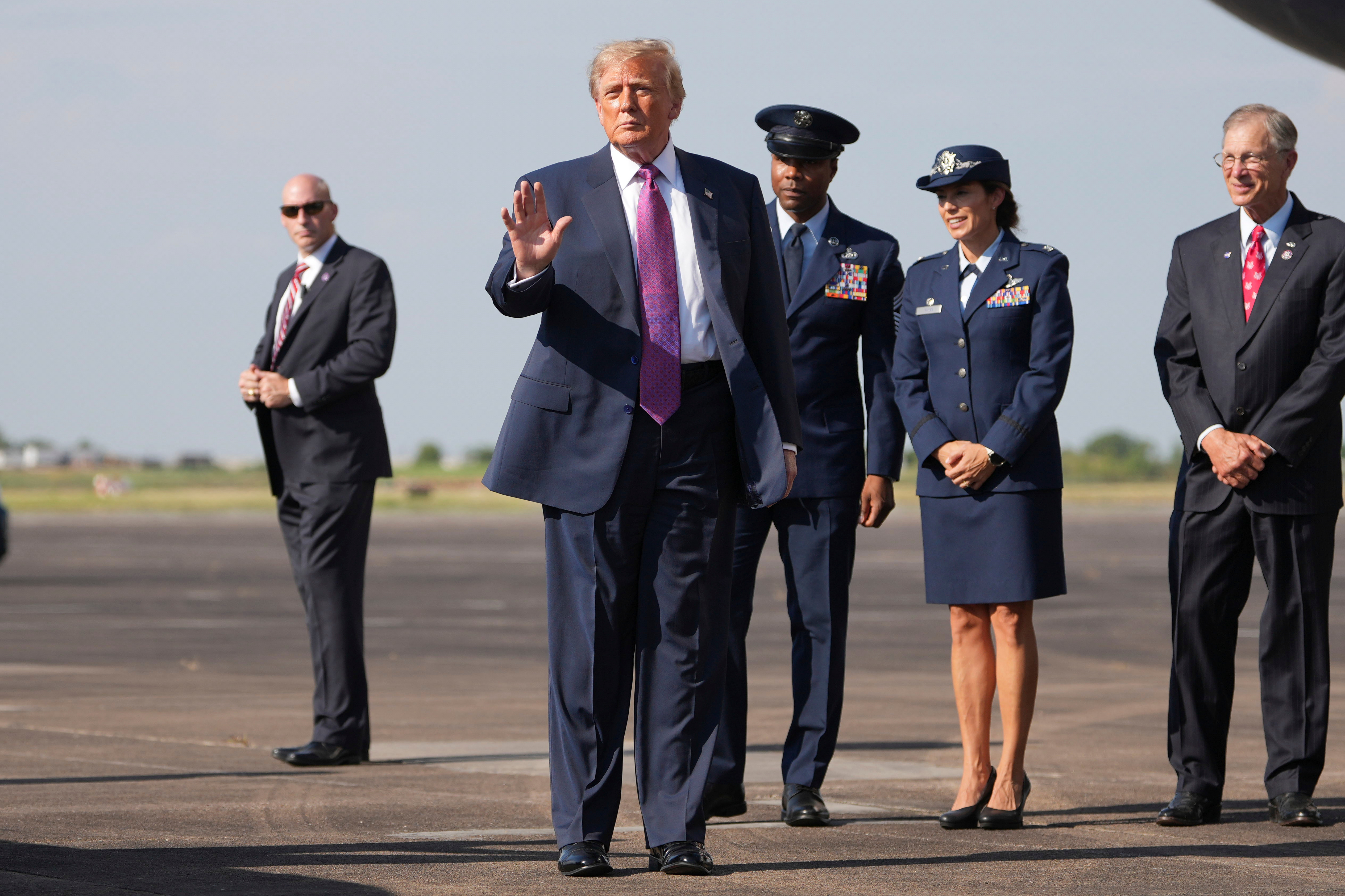President Donald Trump arrives on Air Force One as Rep. Brian Babin, R-Texas, right, looks on, Thursday, Aug. 27, 2026, at Ellington Airport in Houston. (AP Photo/Mark Schiefelbein)