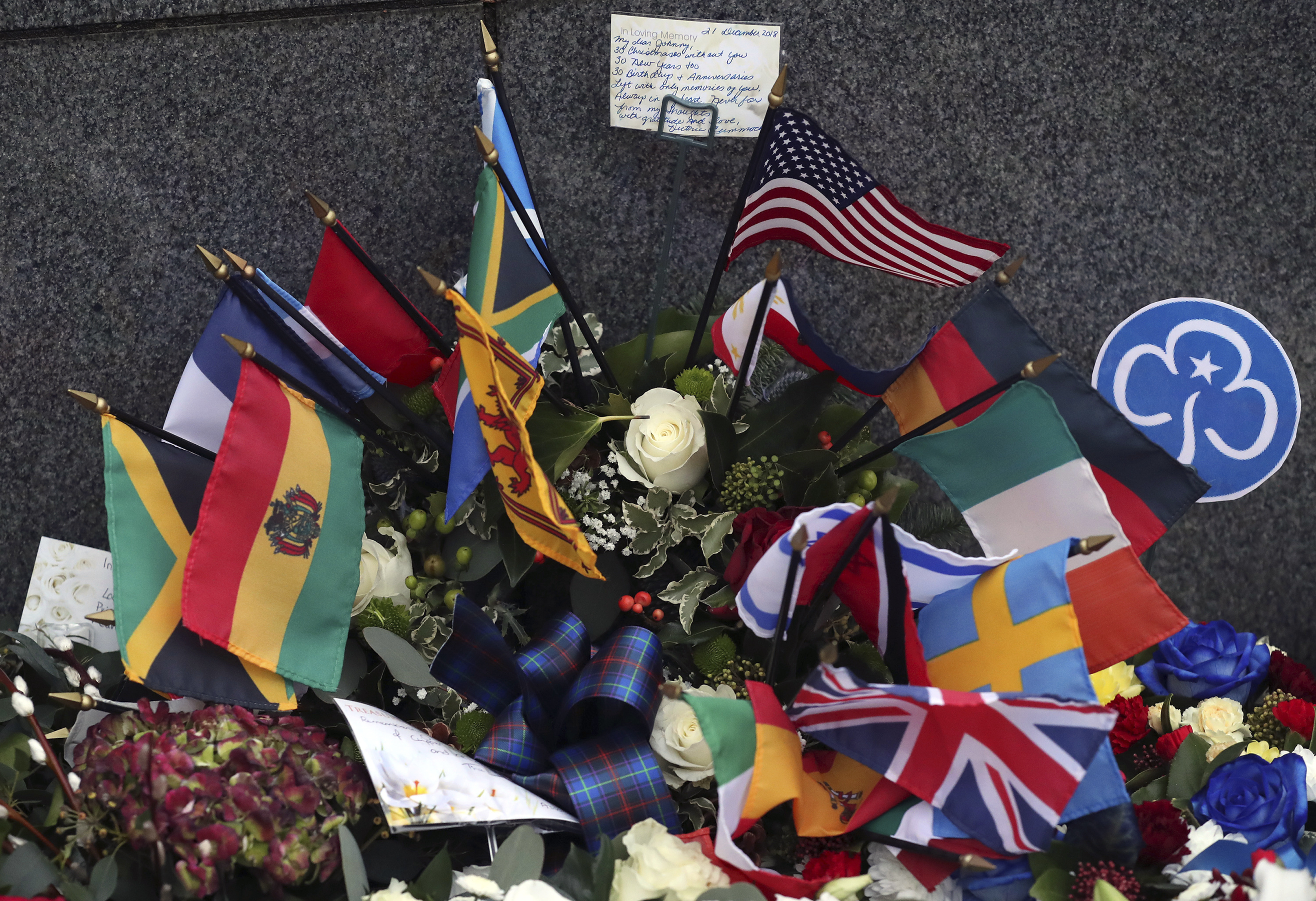 A general view of floral tributes which have been laid by the main memorial stone in memory of the victims of Pan Am flight 103 bombing, in the garden of remembrance at Dryfesdale Cemetery, near Lockerbie, Scotland. Friday Dec. 21, 2018. Memorial services are being held in Scotland and the United States to remember the 270 people killed when a Pan Am passenger plane exploded over the town of Lockerbie 30 years ago. (AP Photo/Scott Heppell)