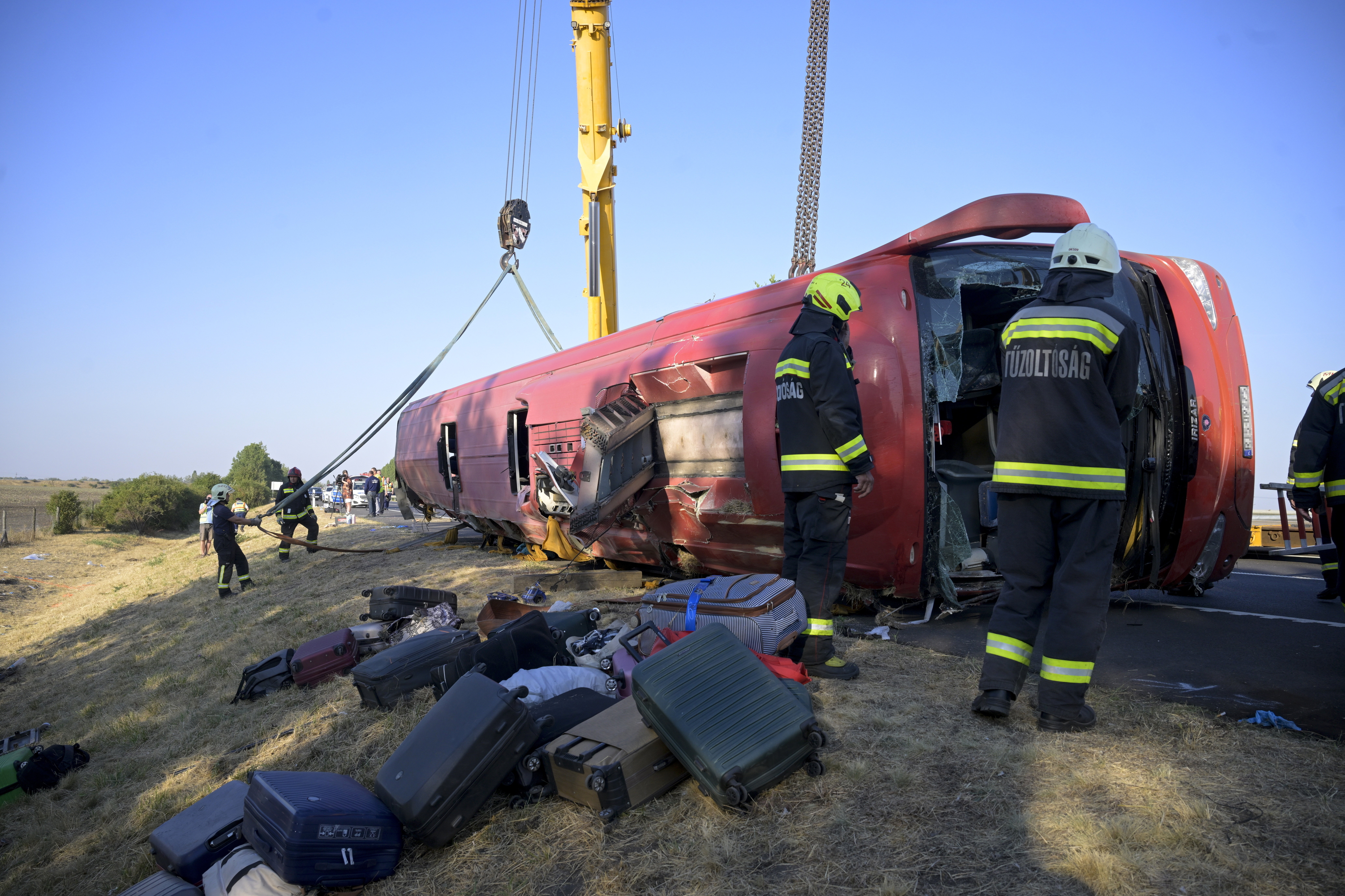 Emergency services work at the scene after a tourist bus crashed in eastern Hungary