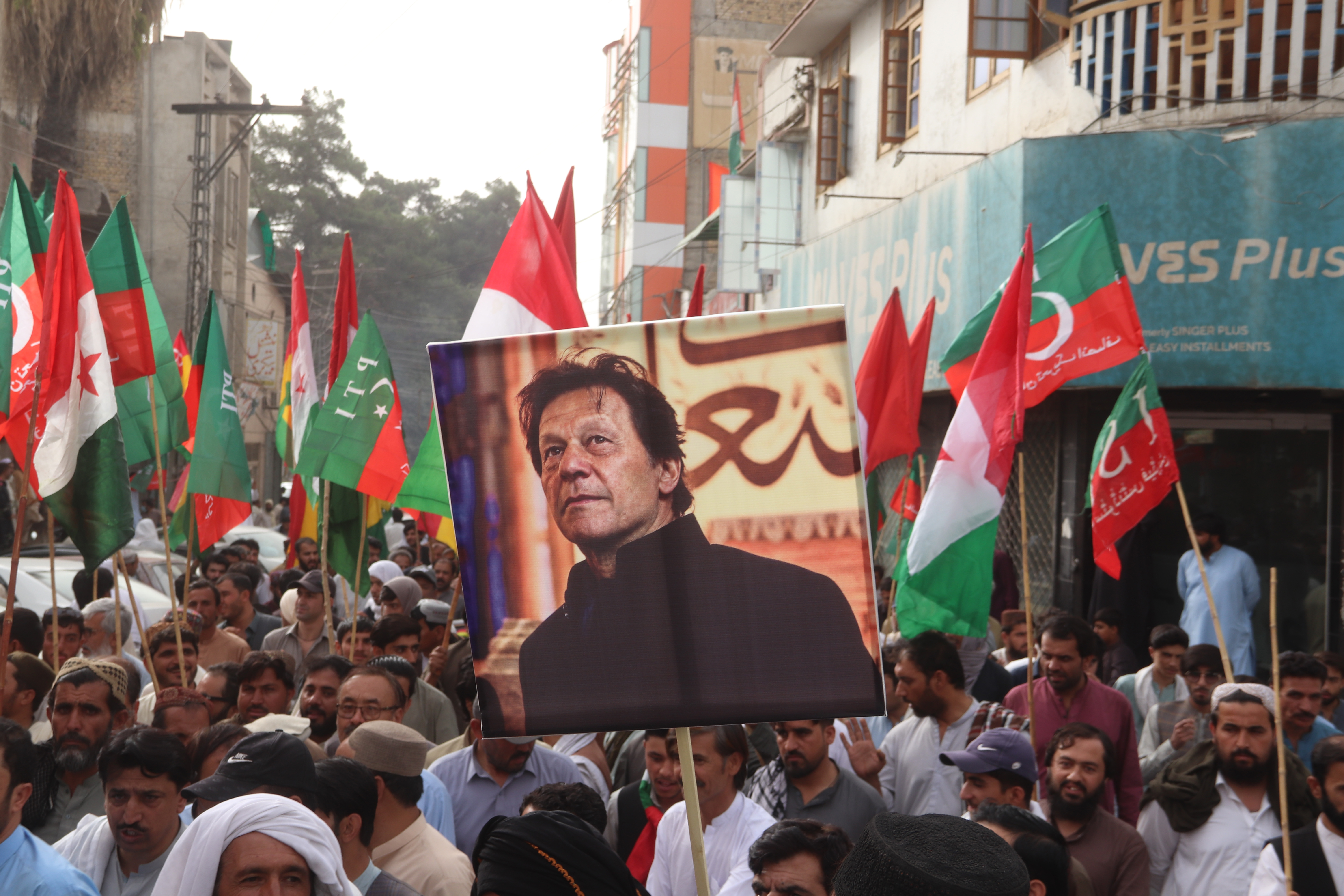 Demonstrators hold pictures of former Prime Minister Imran Khan.