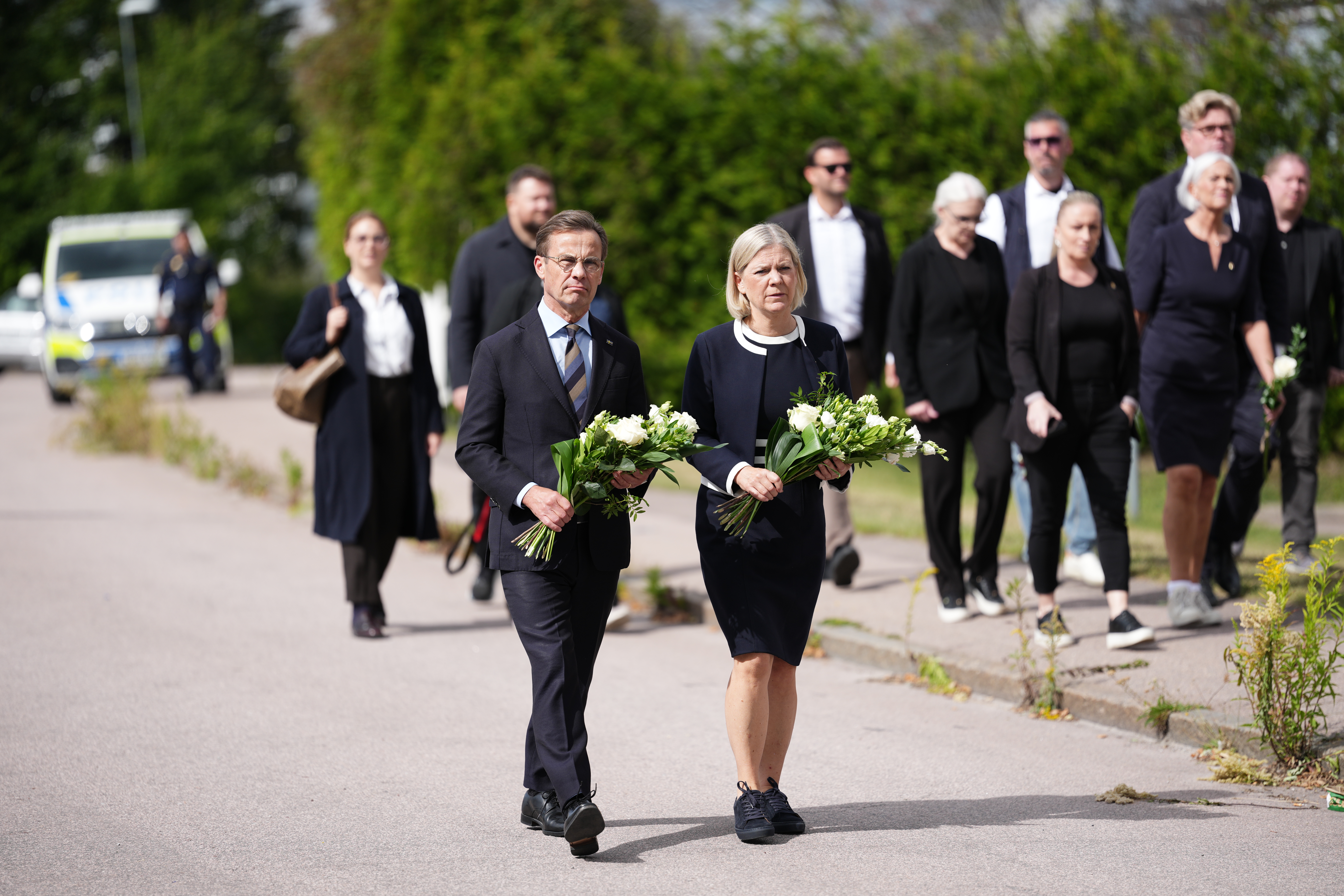 epa13184159 Swedish Prime Minister Ulf Kristersson (L) and Social Democratic Party leader Magdalena Andersson visit the makeshift memorial, one day after an attack carried out by a man with a sword in Fagersta, Sweden, 22 August 2026. A 17-year-old girl was killed and three others were injured at the school after an attack by a man with a sword on 21 August. EPA/Magnus Lejhall SWEDEN OUT