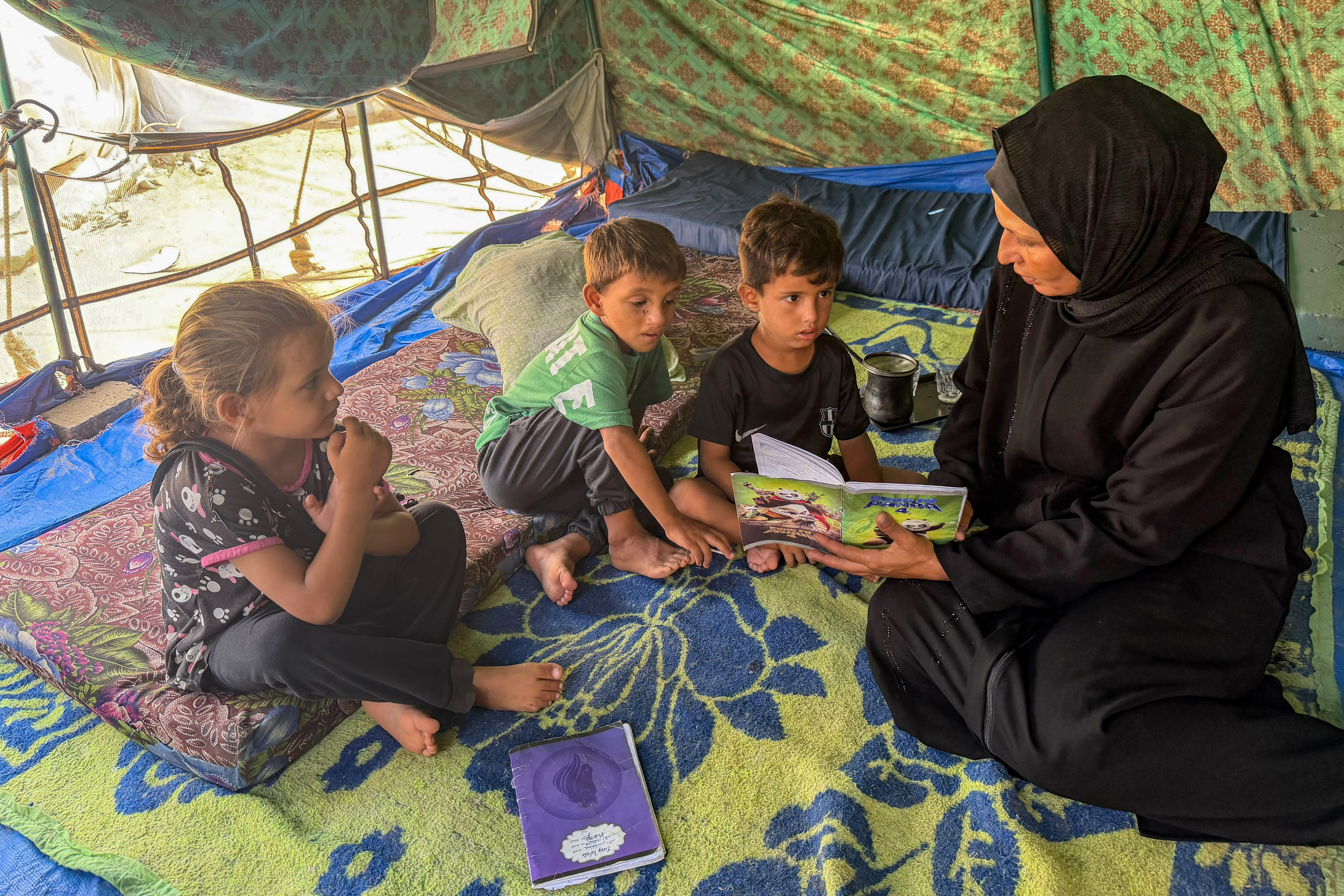 Eman Shamia and her children in their tent.