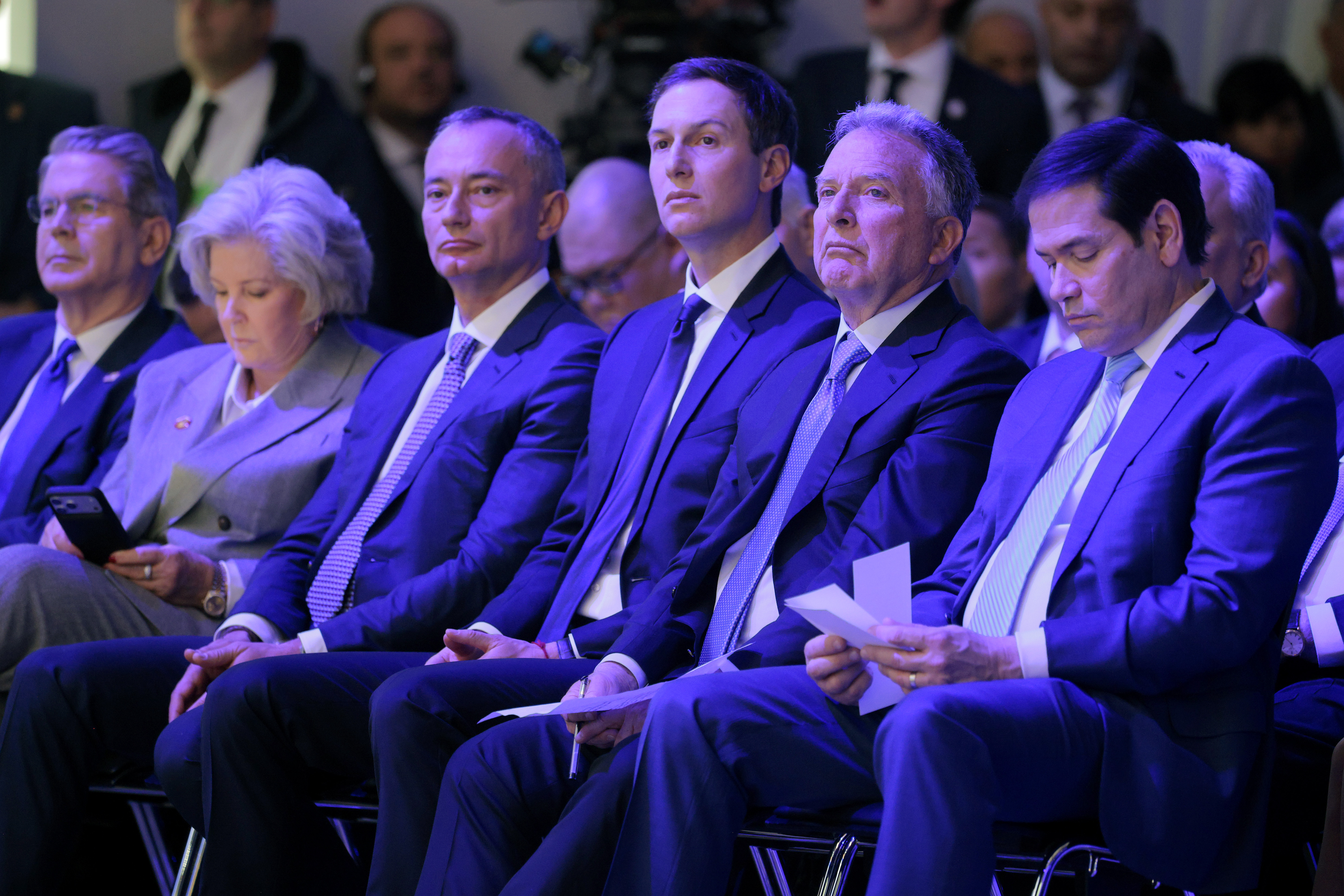 DAVOS, SWITZERLAND - JANUARY 22: (L-R) United States Secretary of the Treasury Scott Bessent, White House Chief of Staff Susie Wiles, former UN Middle East envoy Nickolay Mladenov, Donald Trump's son-in-law Jared Kushner, United States Special Envoy to the Middle East Steve Witkoff and United States Secretary of State Marco Rubio watch as U.S. President Donald Trump presents the “Board of Peace” onstage at the World Economic Forum (WEF) on January 22, 2026 in Davos, Switzerland. The US-backed “Board of Peace” is intended to administer the fragile ceasefire in the Gaza Strip after the war between Israel and Hamas. The final makeup of the board has not been confirmed. (Photo by Chip Somodevilla/Getty Images)