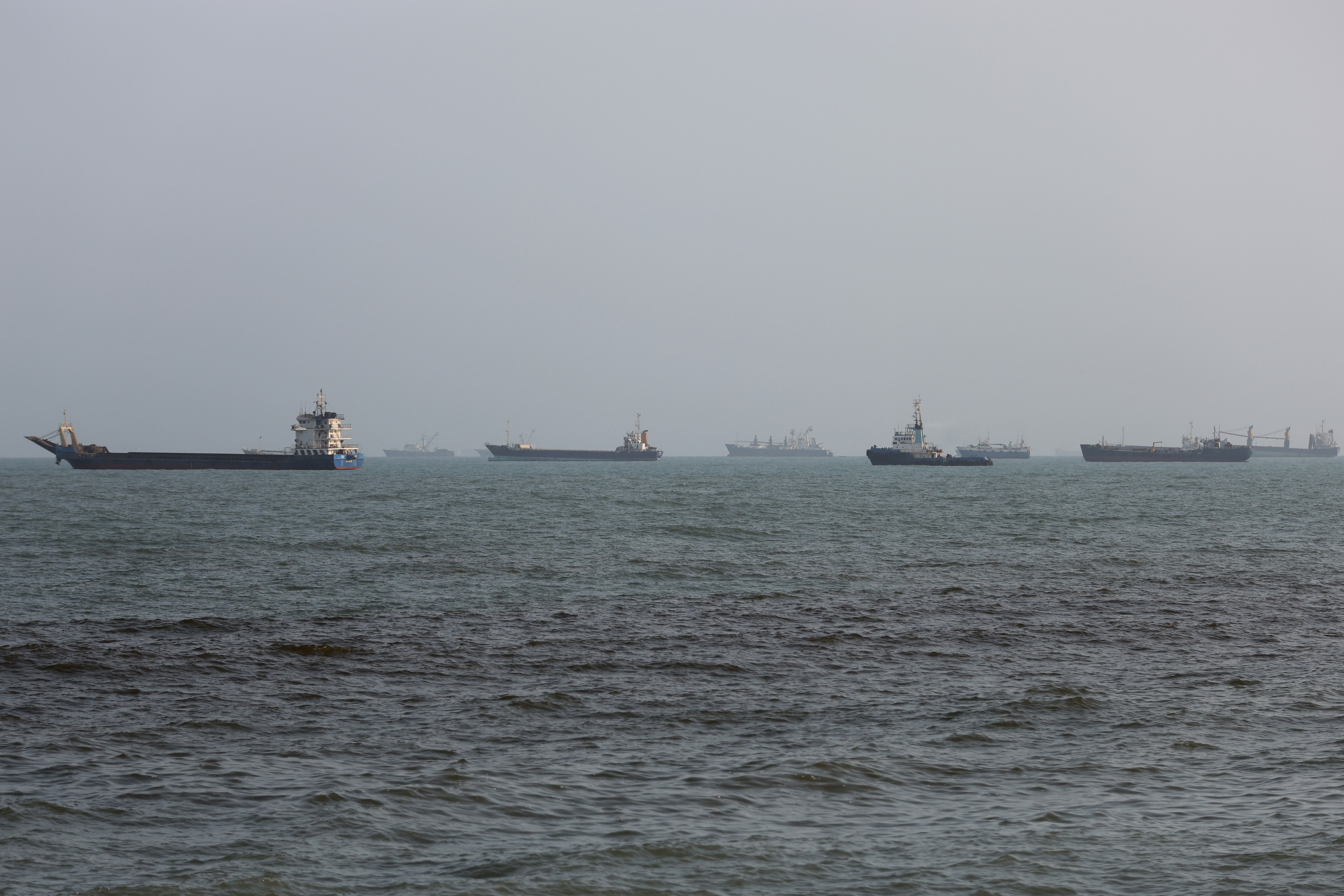 BANDAR ABBAS, IRAN - AUGUST 10: Ships are anchored in the Strait of Hormuz on August 10, 2026 off the coast of Bandar Abbas, Iran. In a recent statement, Iran's Supreme National Security Council said the vital waterway would not reopen until the United States corrects its behavior, demanding that the U.S. end its war on Iran and compensate the country for war damage, among other conditions. Iran has largely halted vessel traffic through the strait with the threat of strikes; meanwhile, the U.S. has imposed a blockade on Iranian ports. (Photo by Ali Saeedi/Getty Images)