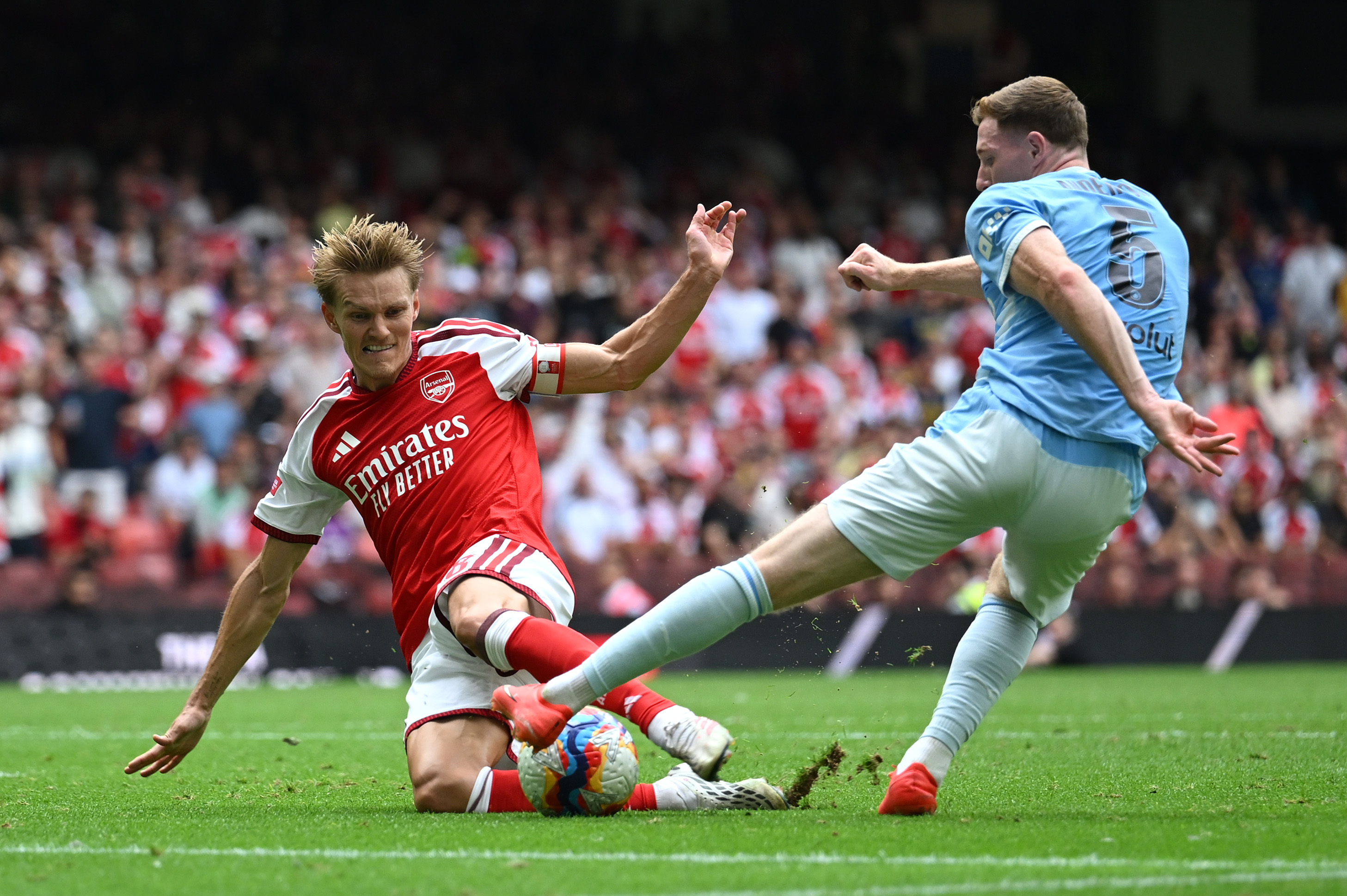 CARDIFF, WALES - AUGUST 16: Martin Odegaard of Arsenal takes a shot while under pressure from Elliot Anderson of Manchester City during the 2026 FA Community Shield match between Arsenal and Manchester City at Principality Stadium on August 16, 2026 in Cardiff, Wales. (Photo by Shaun Botterill/Getty Images)
