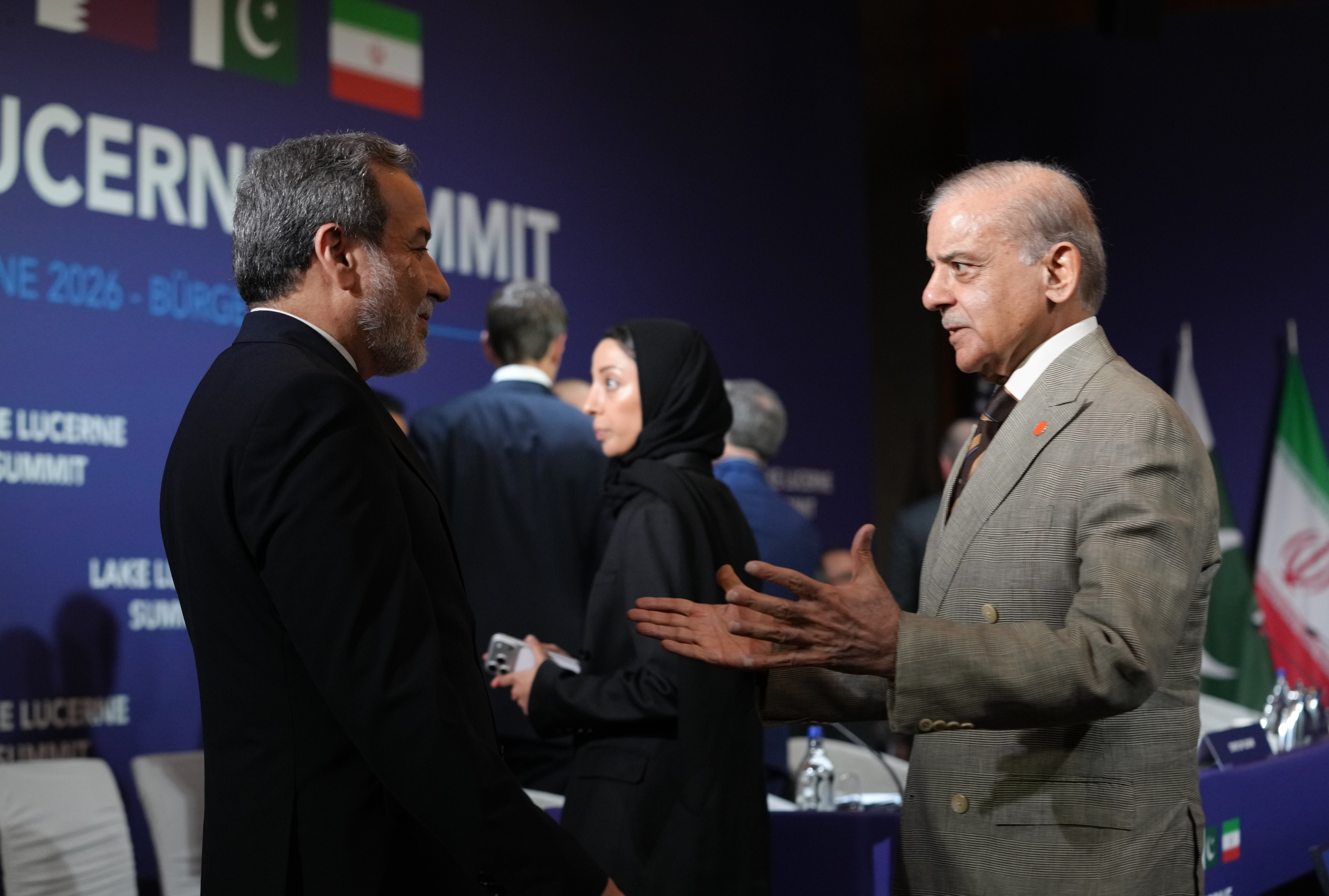 STANSSTAD, SWITZERLAND - JUNE 21: Iran's Foreign Minister Abbas Araqchi and Pakistan's Prime Minister Shehbaz Sharif greet each other before the start of a quadrilateral meeting between the U.S., Iran, Pakistan, and Qatar at the Lake Lucerne Summit, aimed at advancing a deal to end the Middle East conflict at the Buergenstock Resort, Lake Lucerne on June 21, 2026 near Stansstad, Switzerland. US Vice President JD Vance is visiting Switzerland for negotiations with Iran to end the war and open the Strait of Hormuz that have been delayed by Israeli strikes in Lebanon. (Photo by Nathan Howard-Pool/Getty Images)