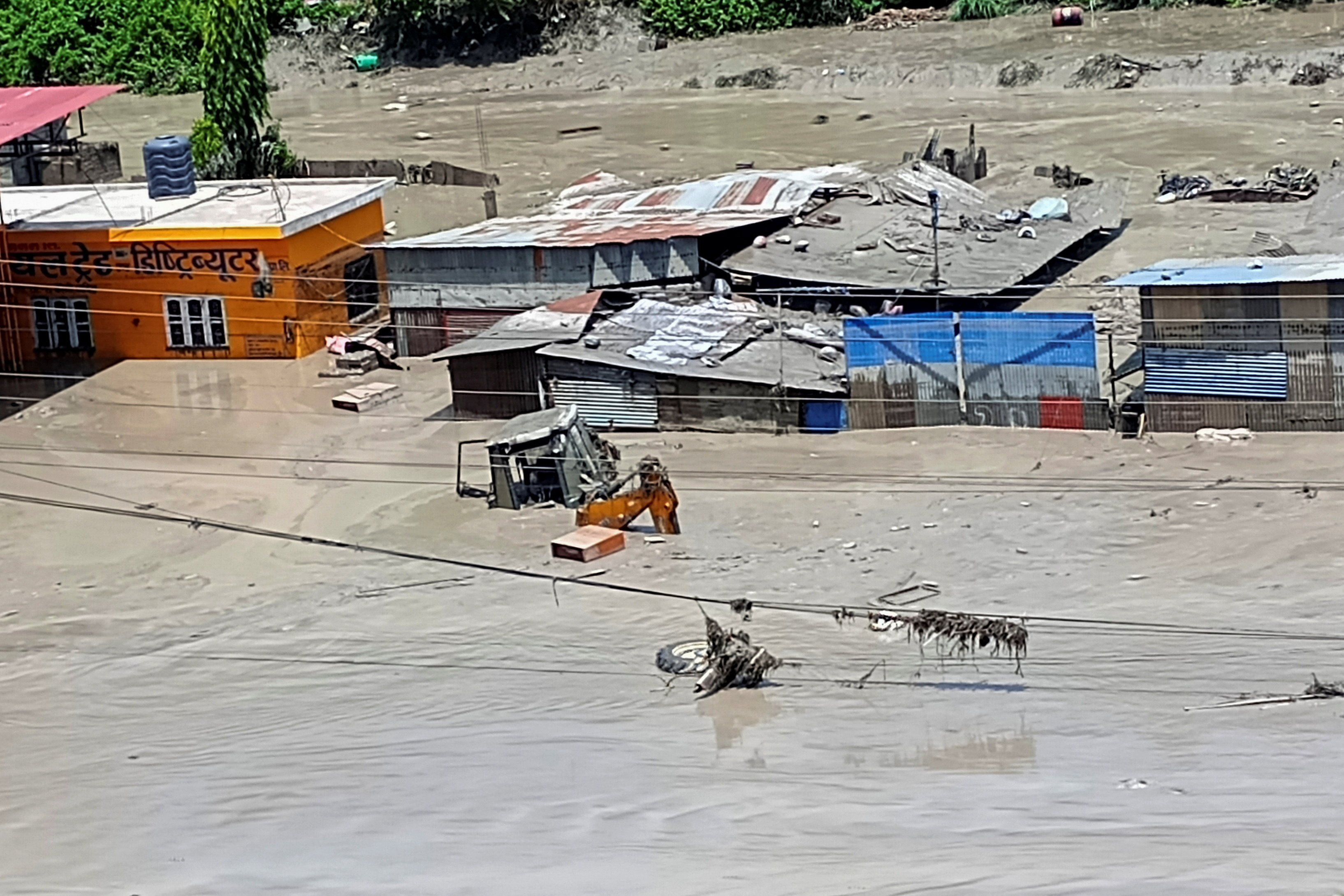 Damaged property and flooded roads following a flash flood in Galchhi in the Dhading district, Nepal, August 26, 2026. Picture taken with a mobile phone. REUTERS/Stringer