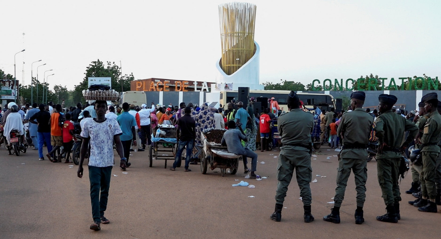 People gather at the Place de la Concertation as security personnel stand guard following a mutineers' attack on the airport and the presidency in Niamey, Niger, August 29, 2026. REUTERS/Stringer