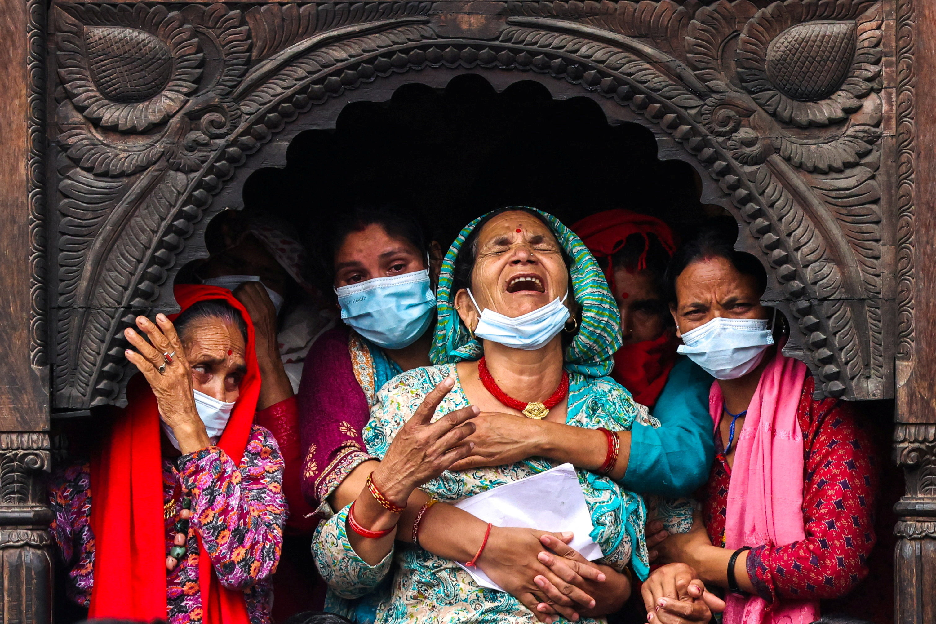 Relatives of Nakul Sharma, 36, who lost his life in the deadly flash floods and a mudslide, mourn during his cremation rituals on the premises of Pashupatinath Temple in Kathmandu